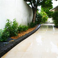 Sandstone entrance to pool area, with bluestone edging.  Garden edging, lawn edging, garden edging products, landscape edging.