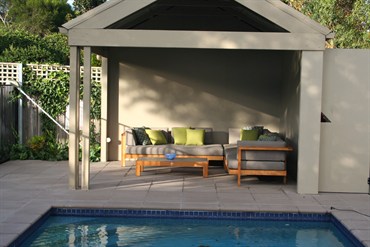 Poolside cabana with contemporary furniture. 