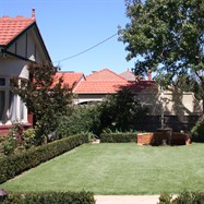   Formal hedging, turf, rose garden, cottage garden with formal pond and screening