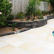 Bluestone retaining wall, contrasting will sandstone paving.  Garden edging, lawn edging, garden edging products, landscape edging.